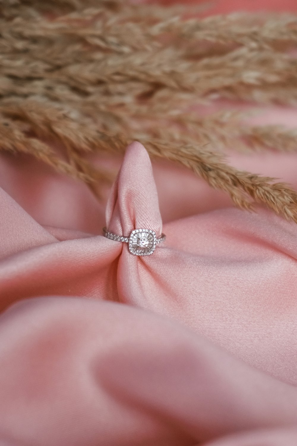 pink textile with silver diamond ring