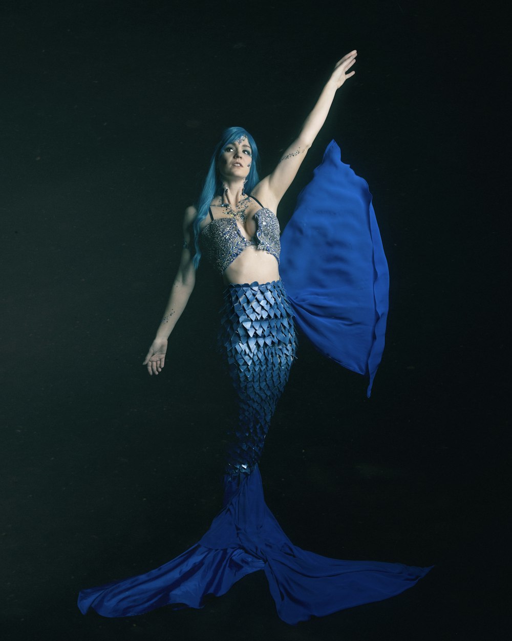 woman in blue dress with blue wings