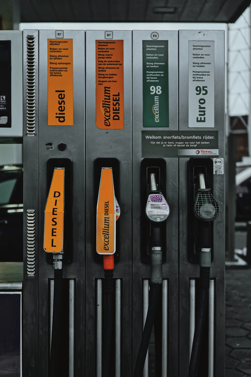 a row of gas pumps sitting next to each other