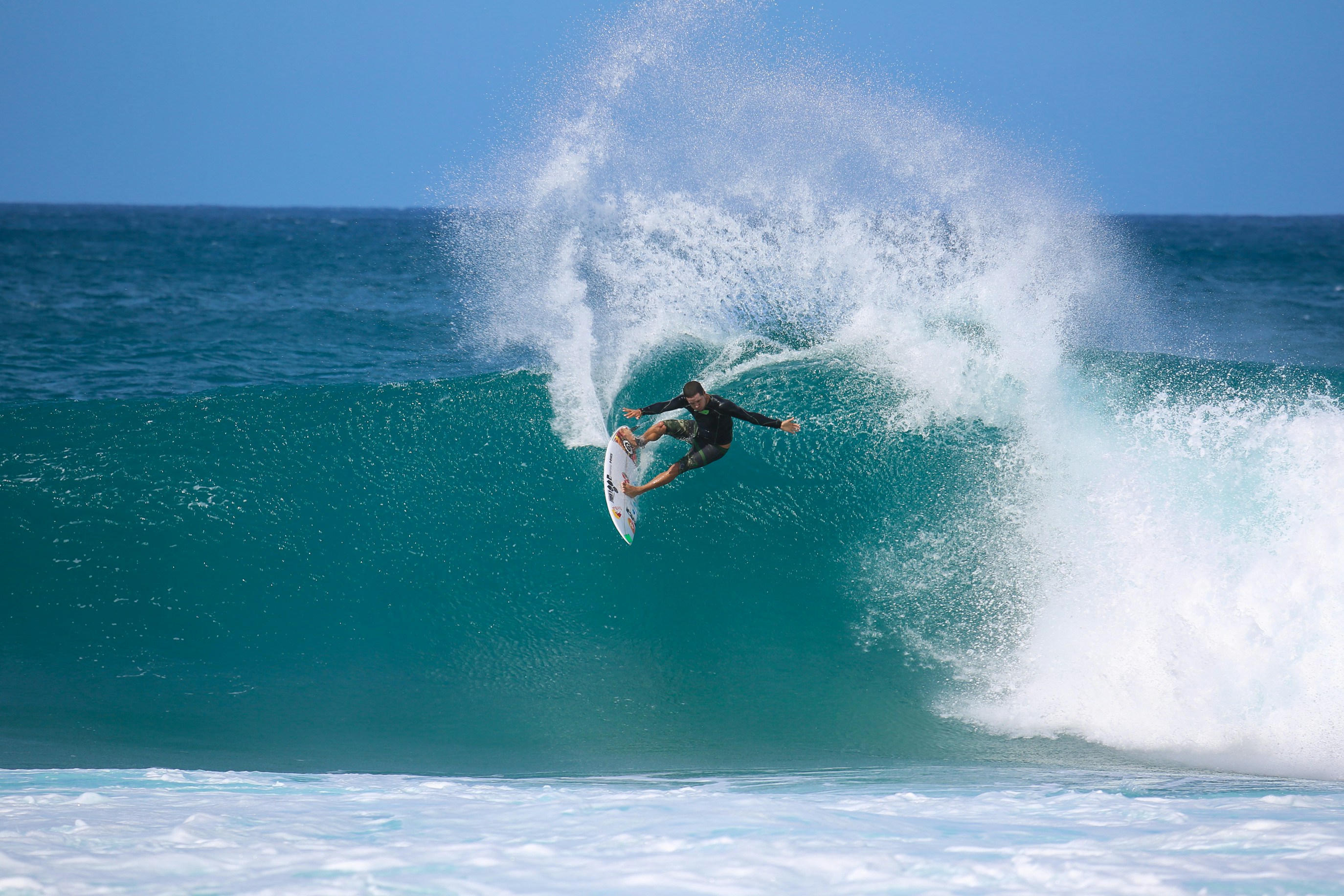 man surfing on sea waves during daytime