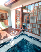 A family enjoying a poolside meal at an all-inclusive resort with bright sunshine.