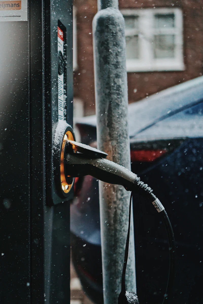 A charging cable connected to a black car