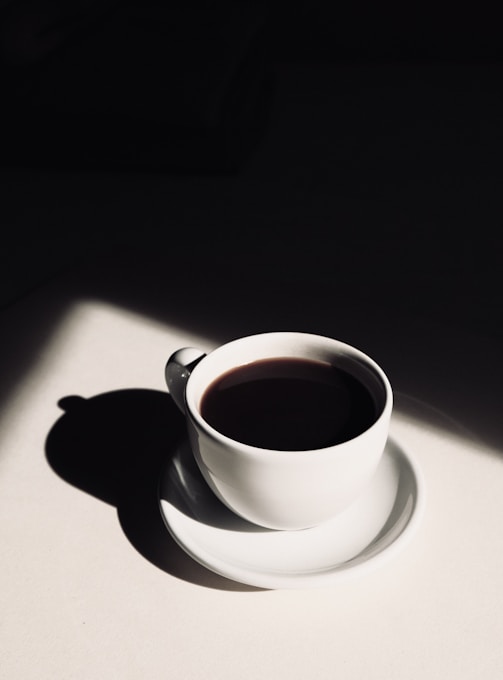 white ceramic teacup on saucer