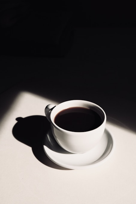 white ceramic teacup on saucer