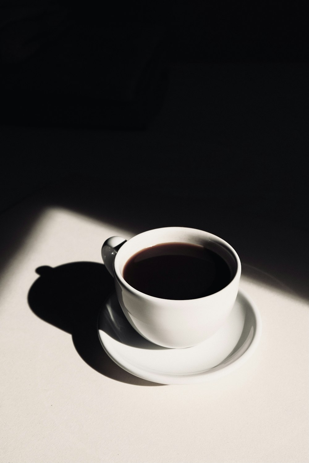 white ceramic teacup on saucer