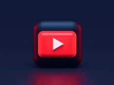 A 3D red play button icon on a dark blue background
