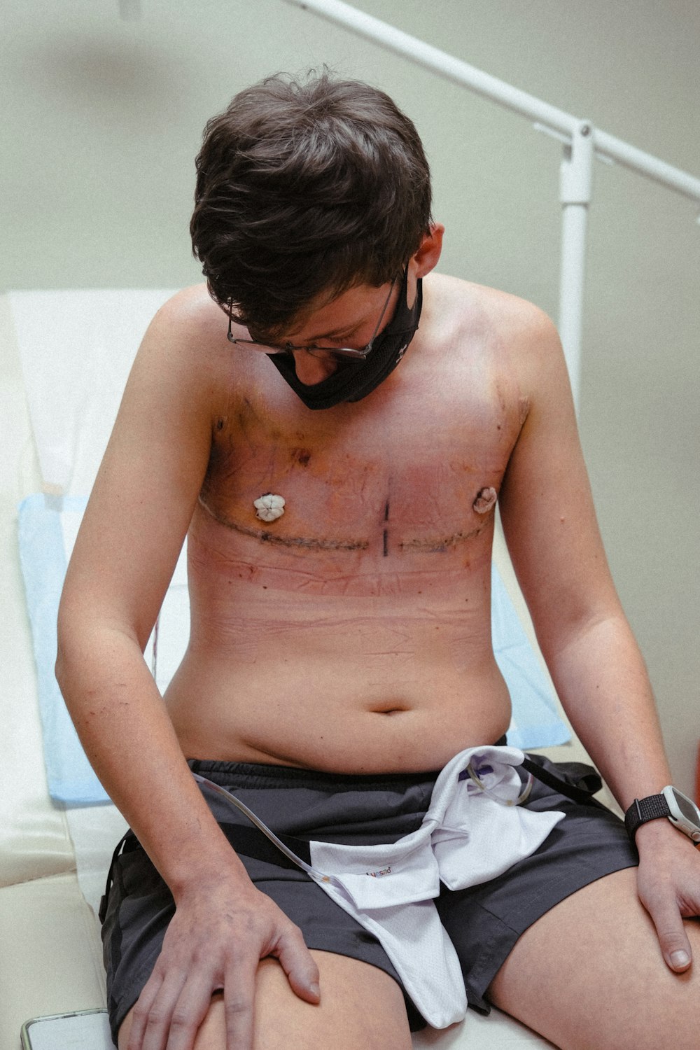 topless man wearing black sunglasses