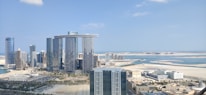 An aerial view of Dubai's skyline with modern buildings and clear blue skies.