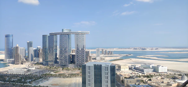 A panoramic view of iconic Gulf city skylines symbolizing job opportunities abroad.