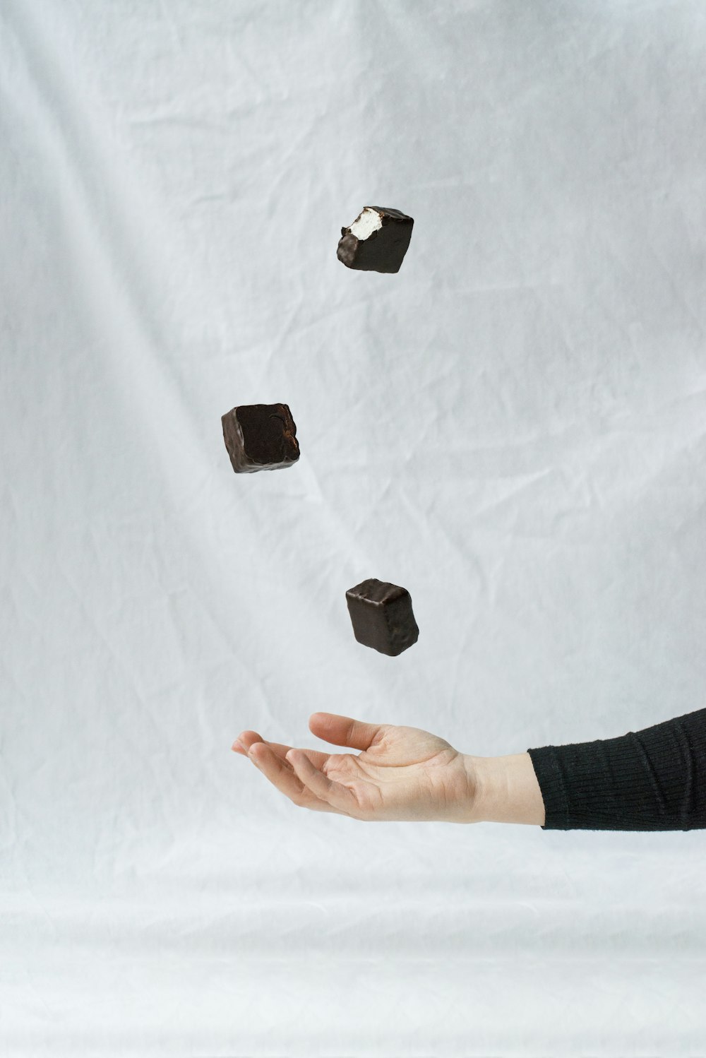 person holding black square stone