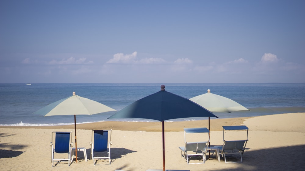 blue and white patio umbrella on beach during daytime