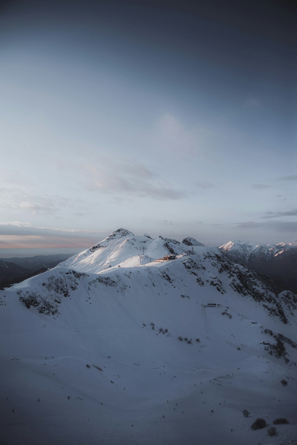 snow covered mountain under cloudy sky during daytime