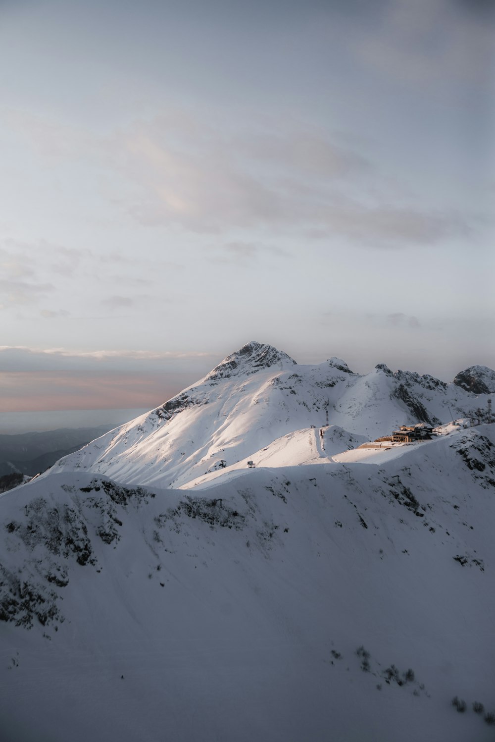 snow covered mountain under cloudy sky during daytime