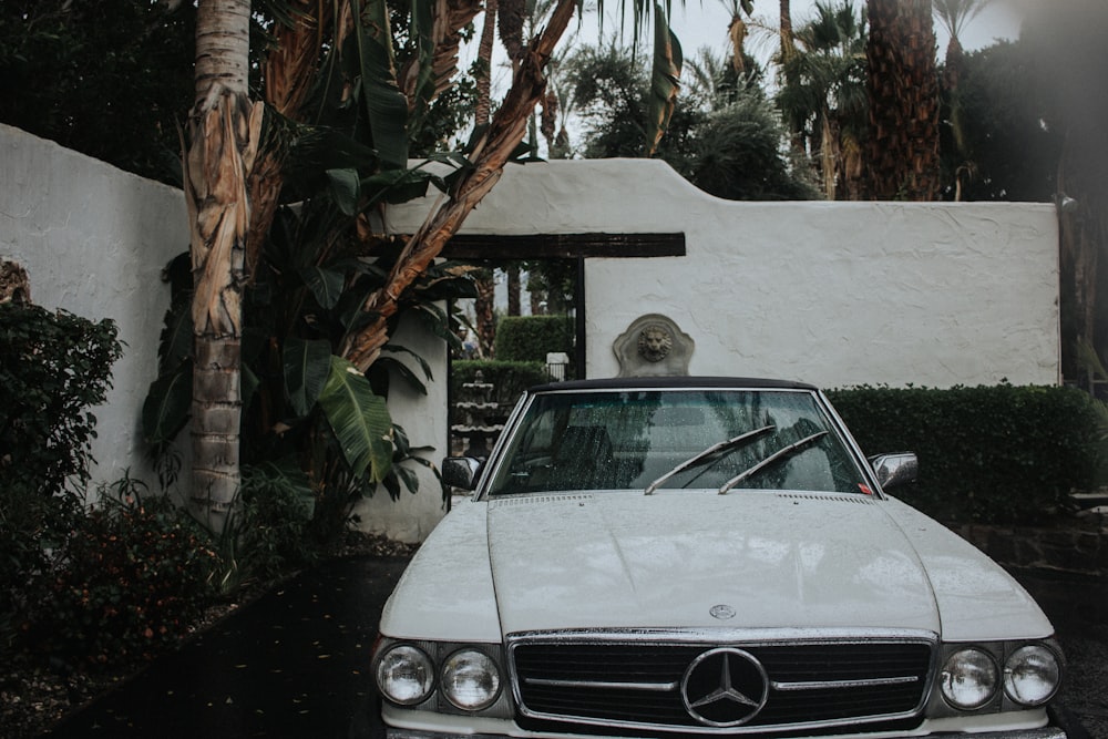 white mercedes benz coupe parked on snow covered ground during daytime