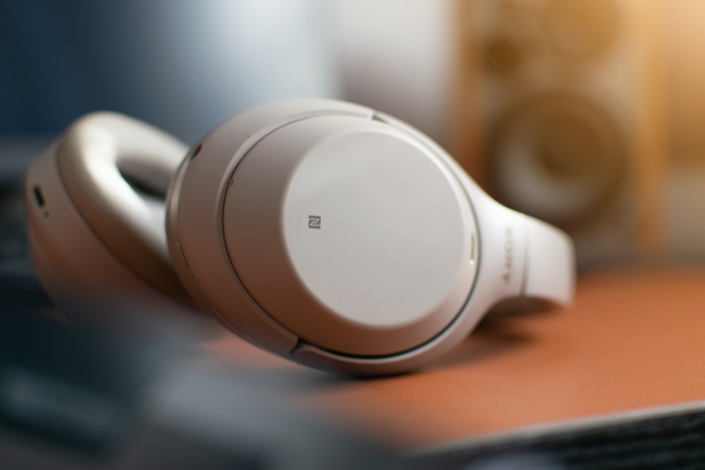 white sony headphones on brown wooden table