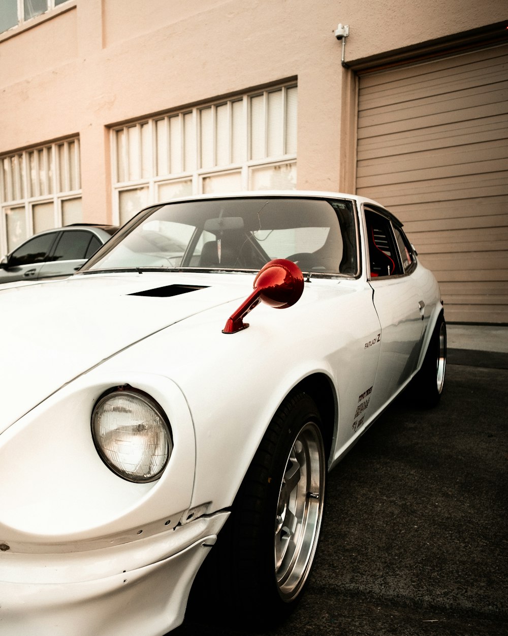 white porsche 911 parked near white building