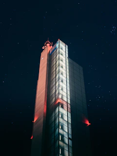 Outdoor LED modem installed on a building facade with city lights in the background