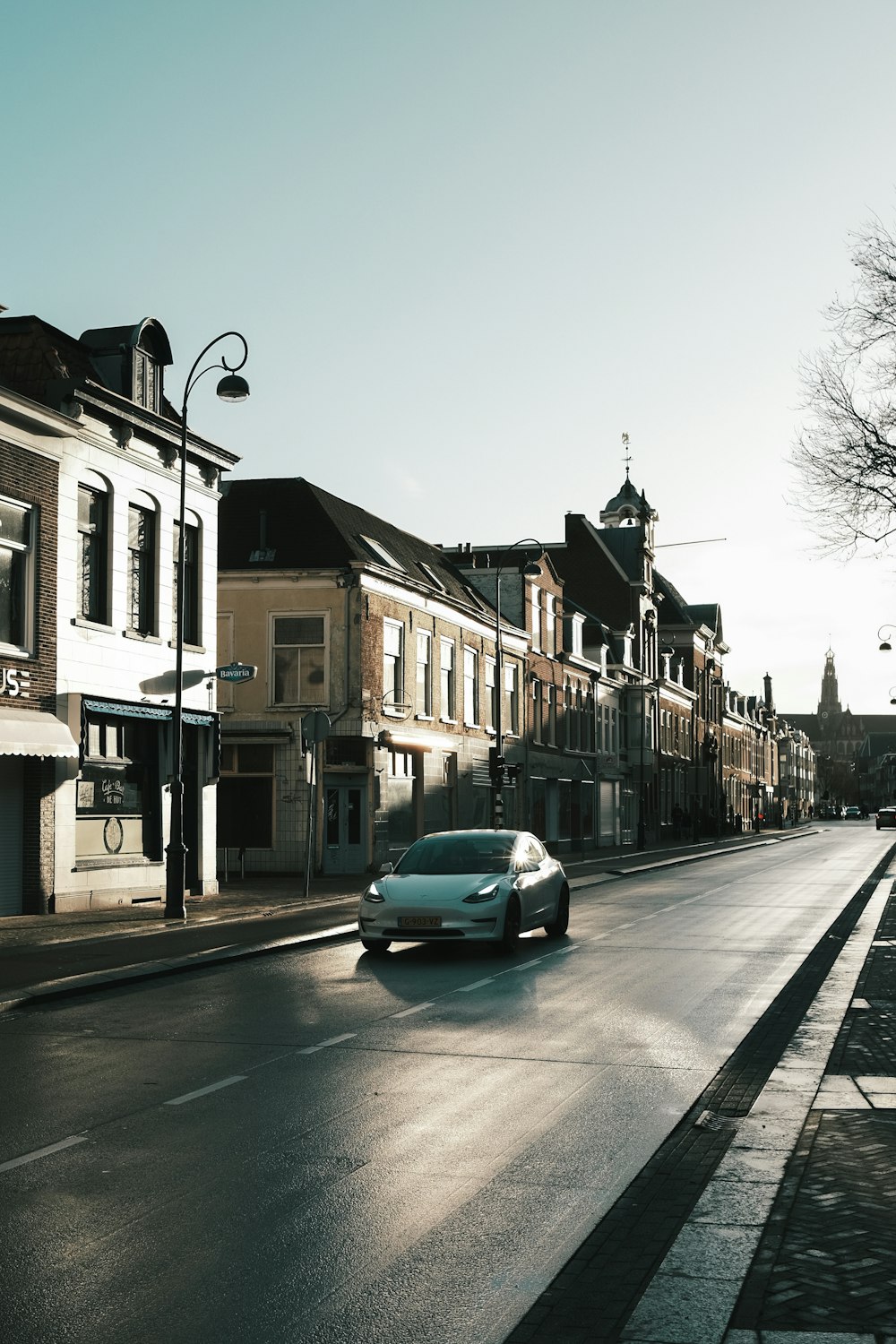 cars parked beside the road near buildings during daytime