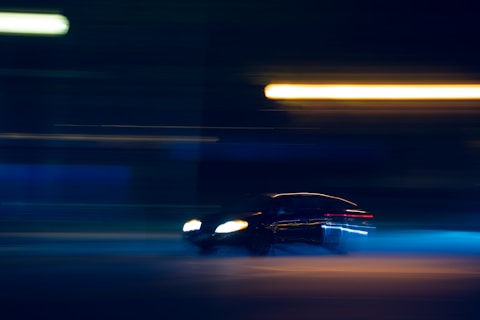 black car on road during night time overspeeding