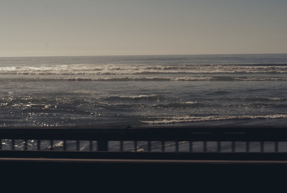 sea waves crashing on beach shore during daytime