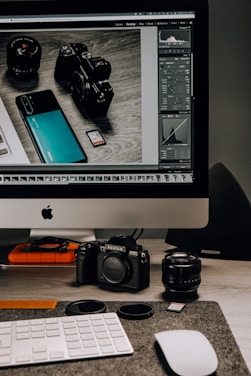 Creative studio workspace with camera equipment and editing tools.