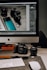 silver iphone 6 beside black and silver camera on brown wooden table