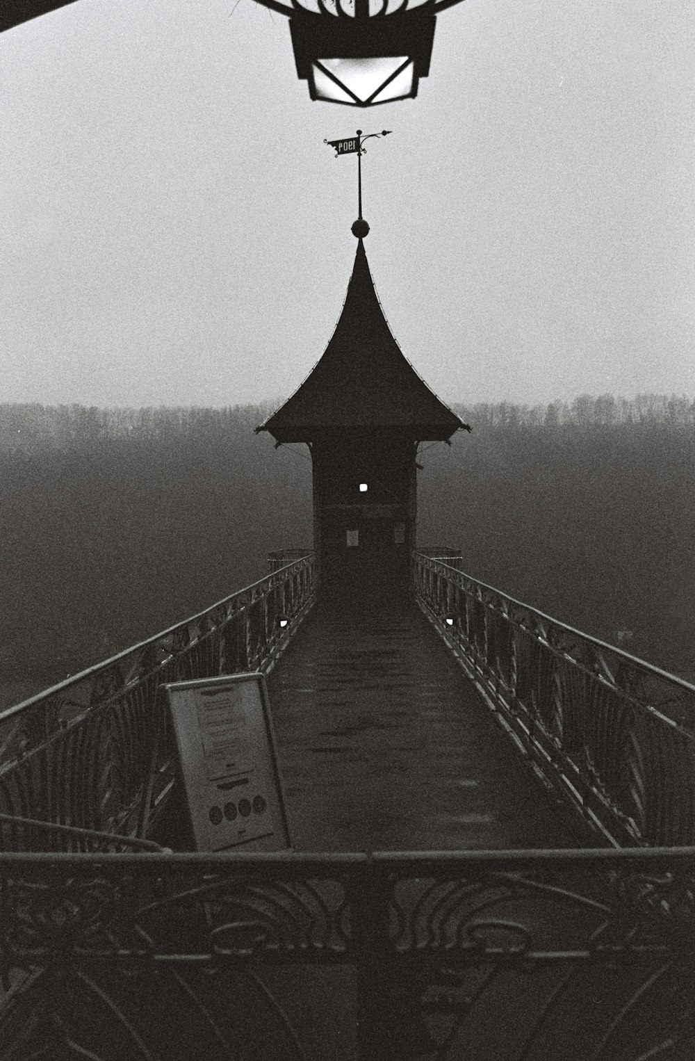 brown wooden bridge over body of water