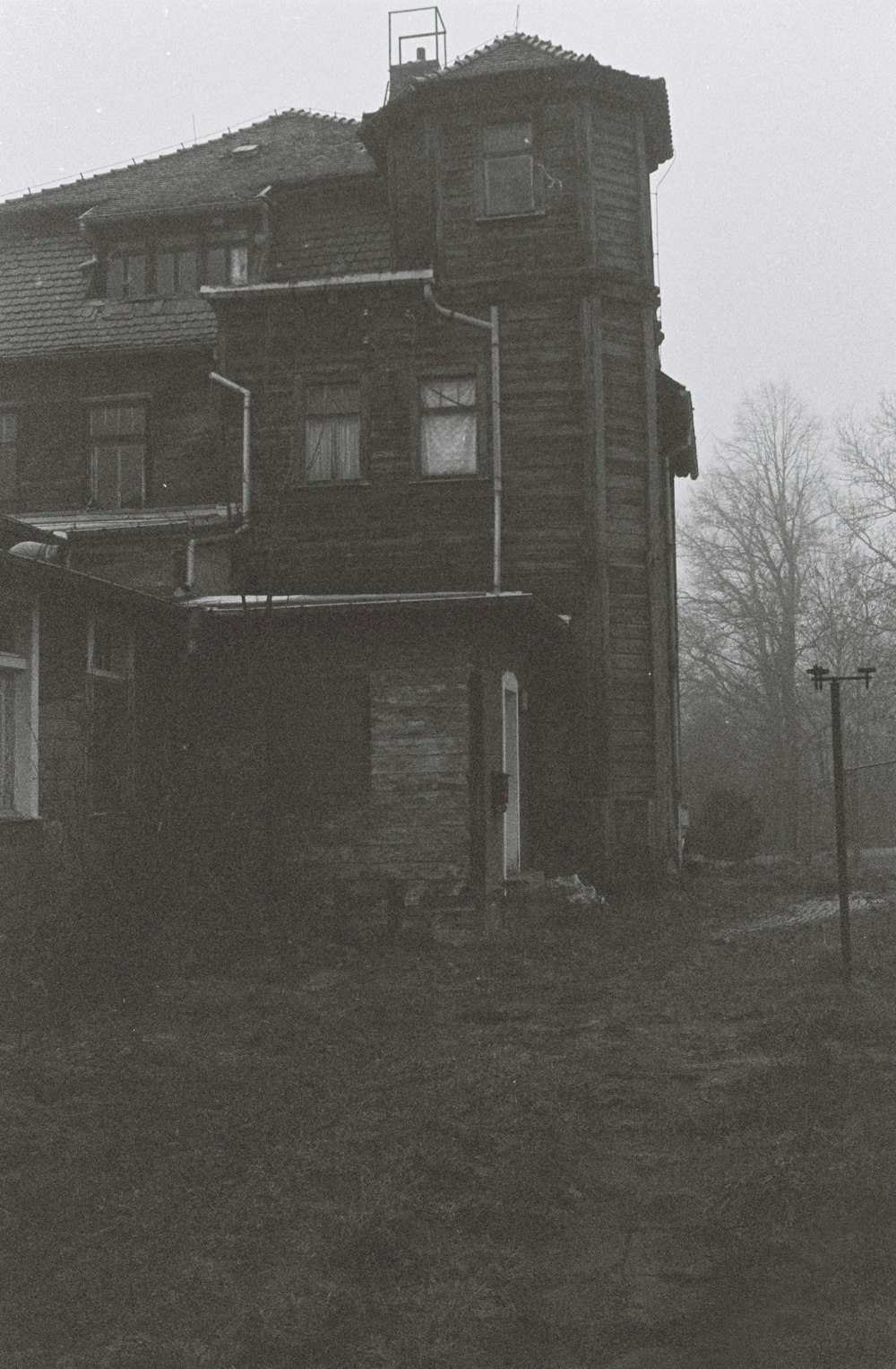 brown concrete house near bare trees during daytime