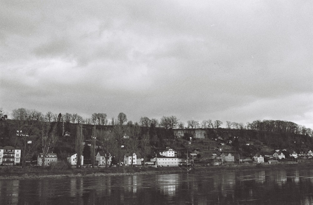 city buildings near body of water under white sky during daytime