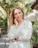 woman in white long sleeve shirt smiling
