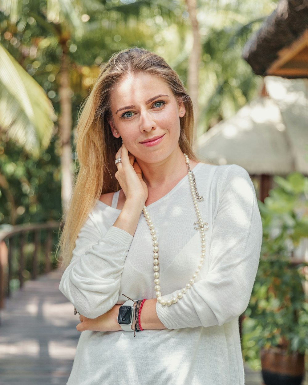 woman in white long sleeve shirt smiling