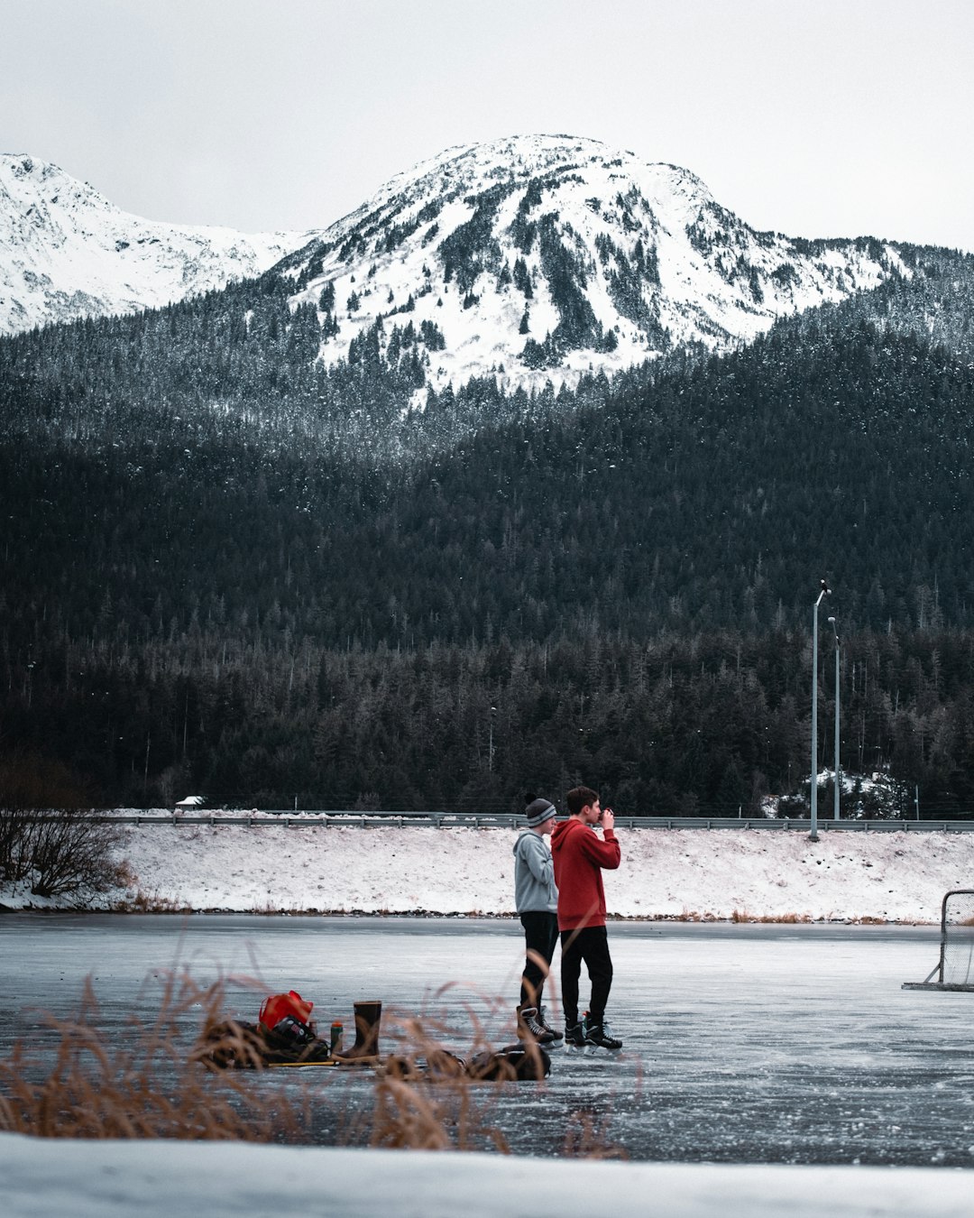 man and woman walking on snow covered ground during daytime