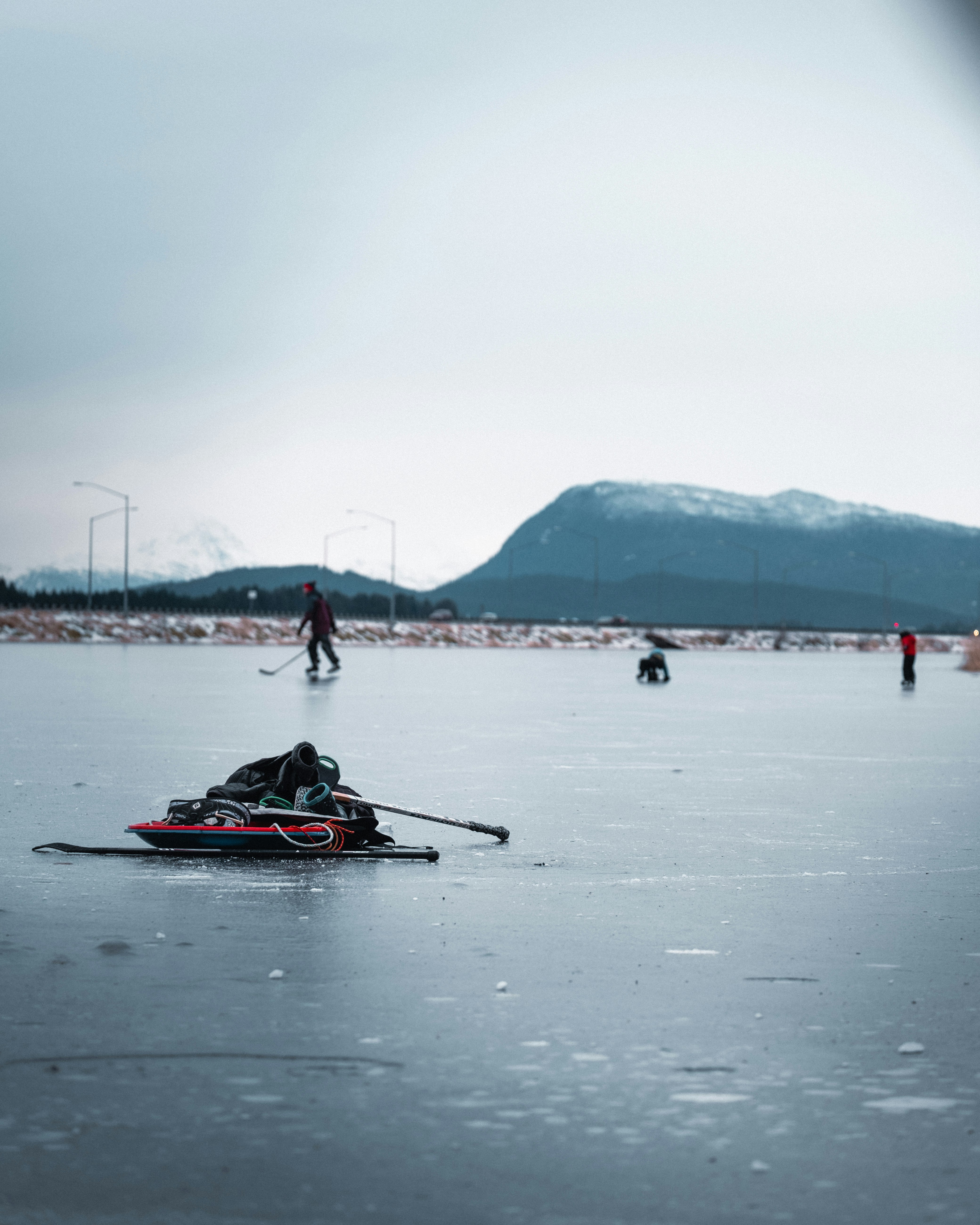 people riding on red kayak on sea during daytime