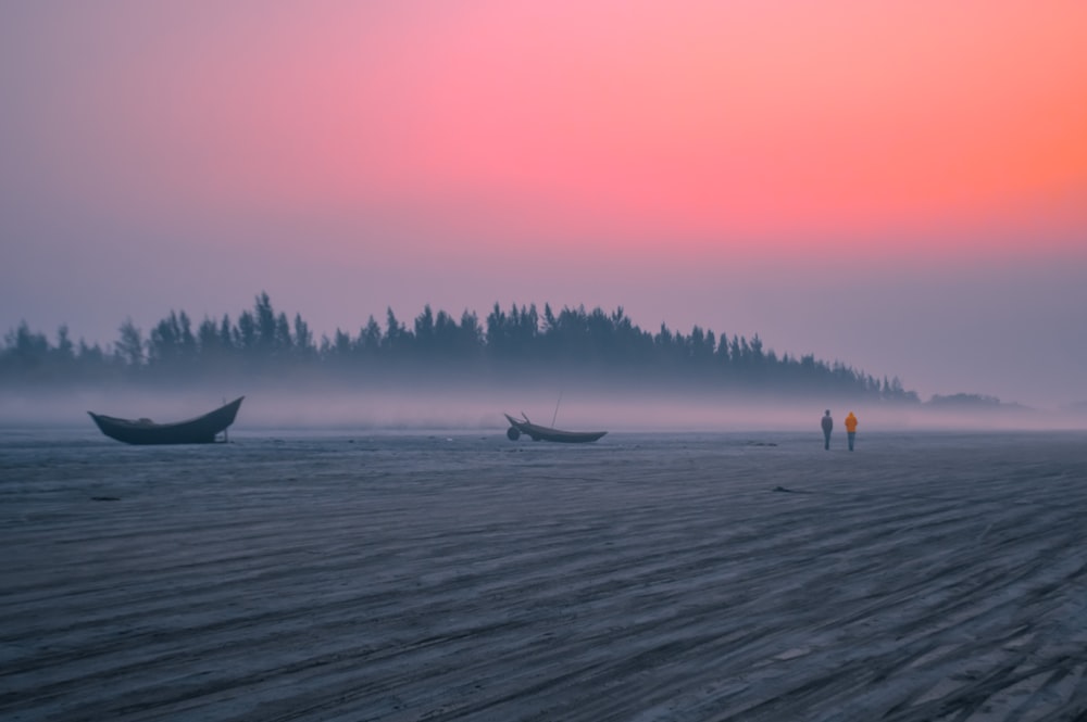 people standing on sea shore during daytime