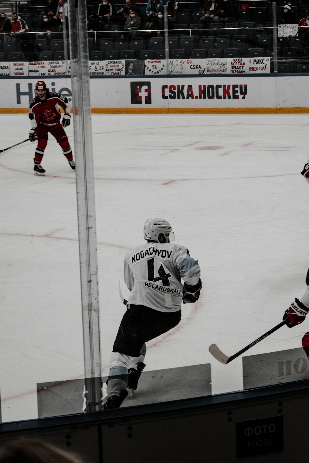 man in white ice hockey jersey playing hockey