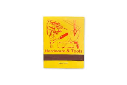 A yellow matchbook cover featuring an illustration of various tools including a drill, a trowel, and a ruler. The text 'Hardware & Tools' is printed in red at the bottom.