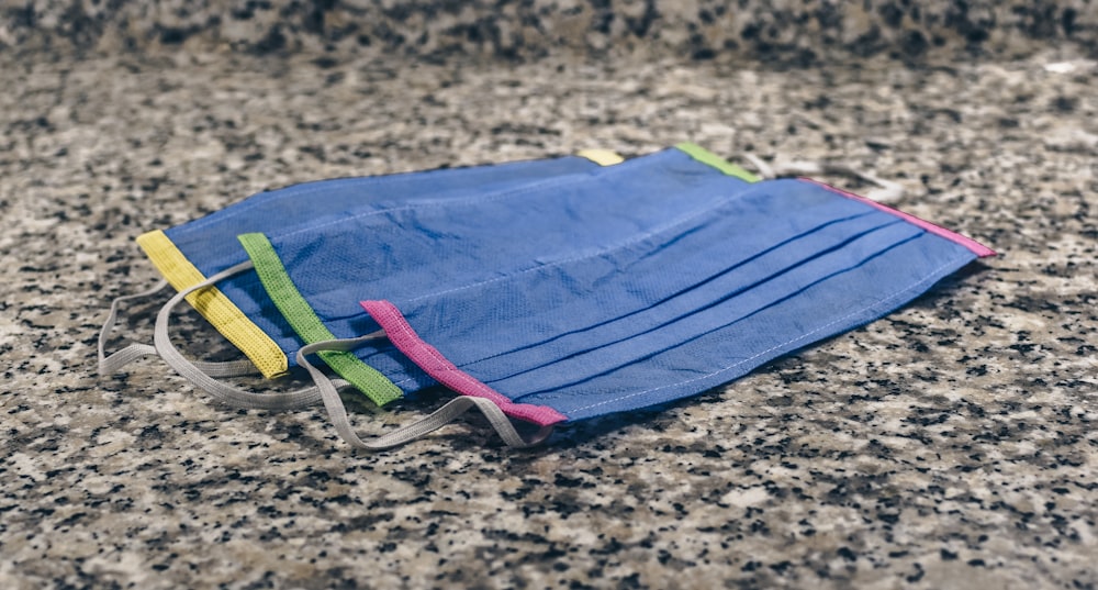 blue green and yellow textile on brown sand