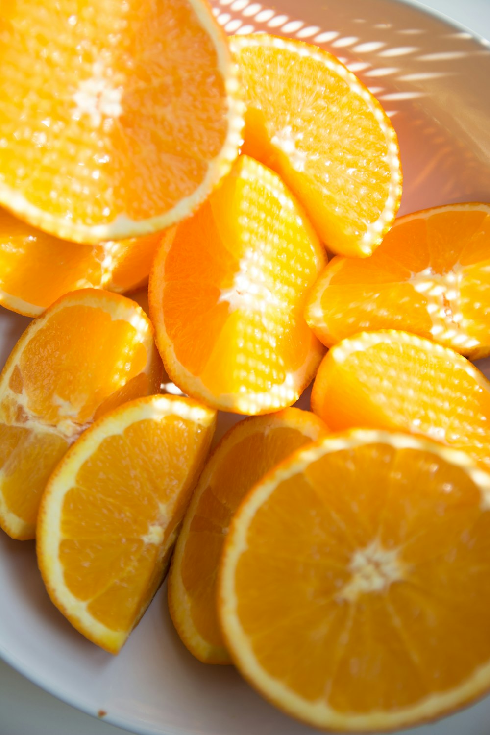 sliced orange fruit on white ceramic plate