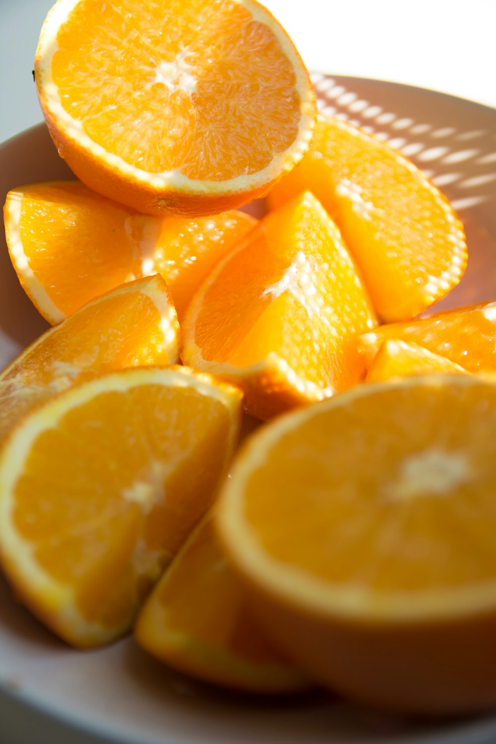 sliced orange fruit on white ceramic plate