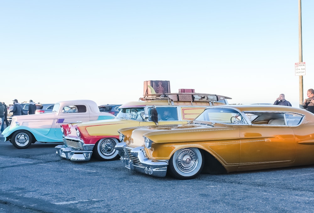 yellow and white vintage cars on parking lot during daytime