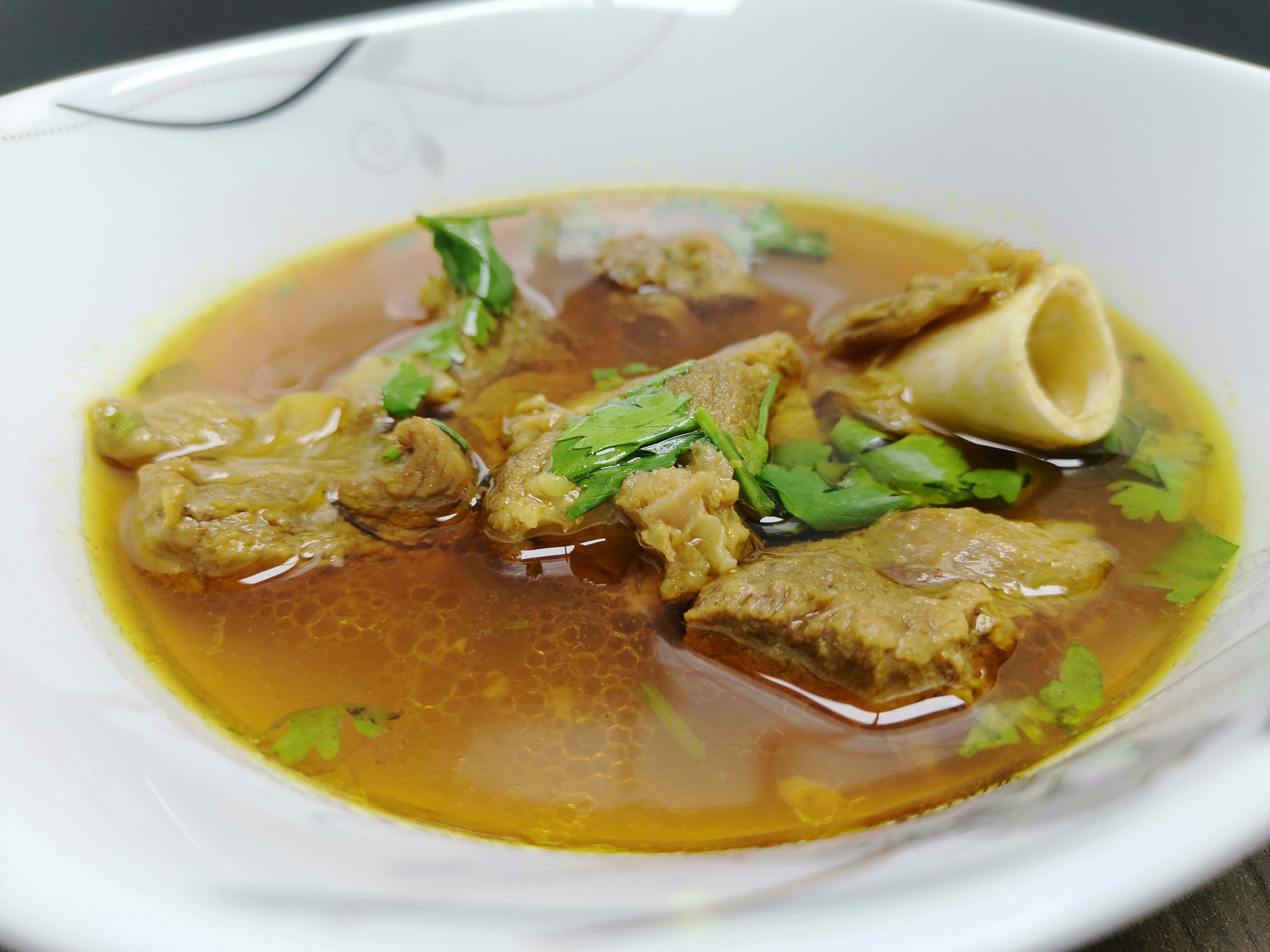 Mutton rib soup with tender ribs in aromatic herbed broth