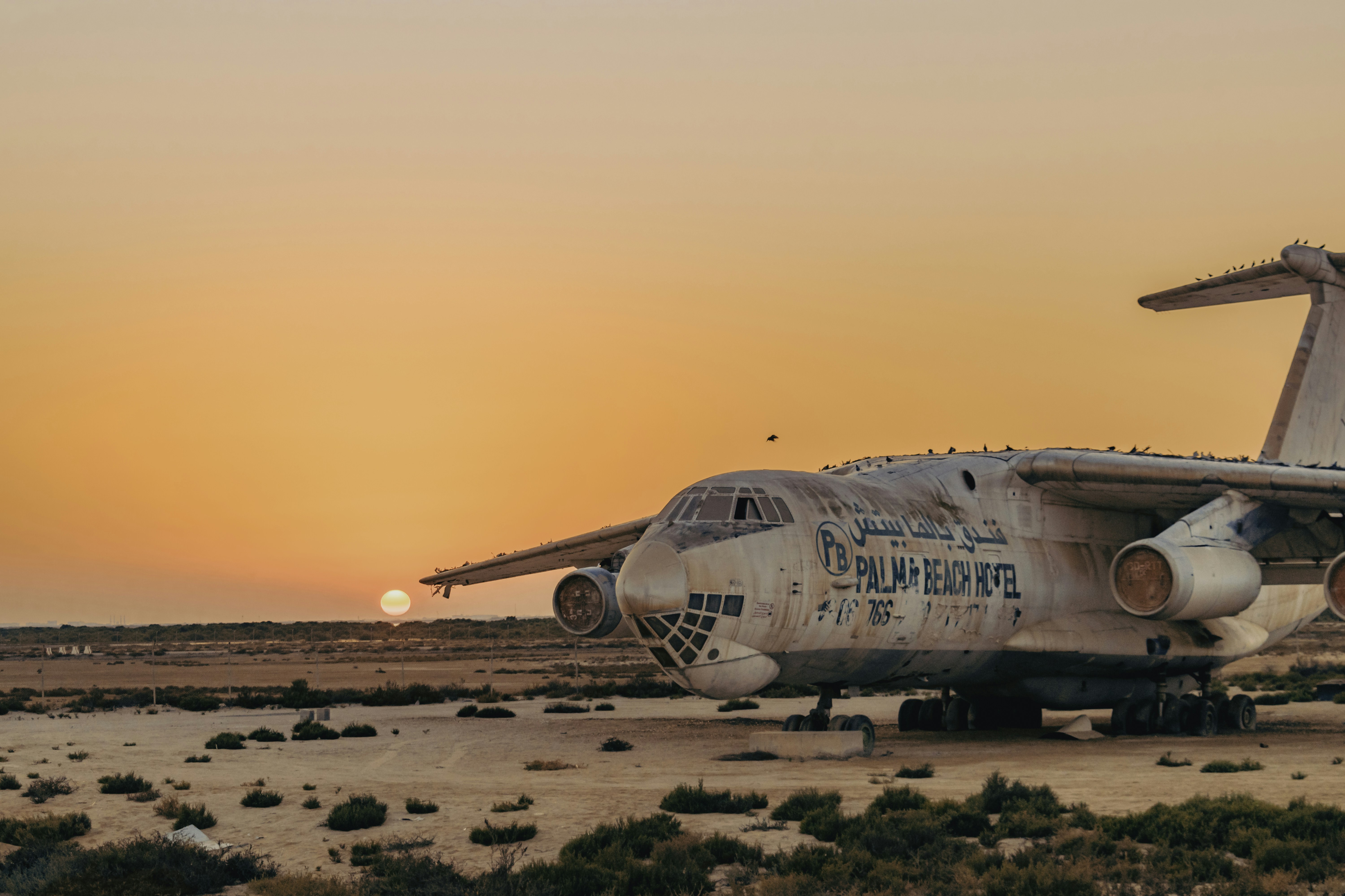 white airplane on brown field during sunset, Abandoned Aircraft at the abandoned Umm Al Quwain Airport, UAE.