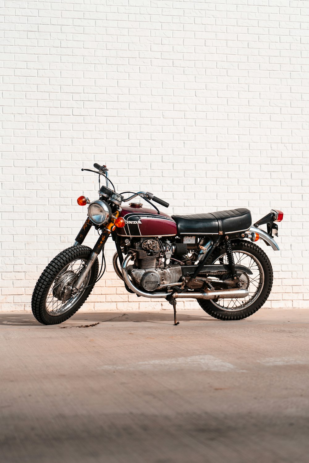 black and red motorcycle near white wall