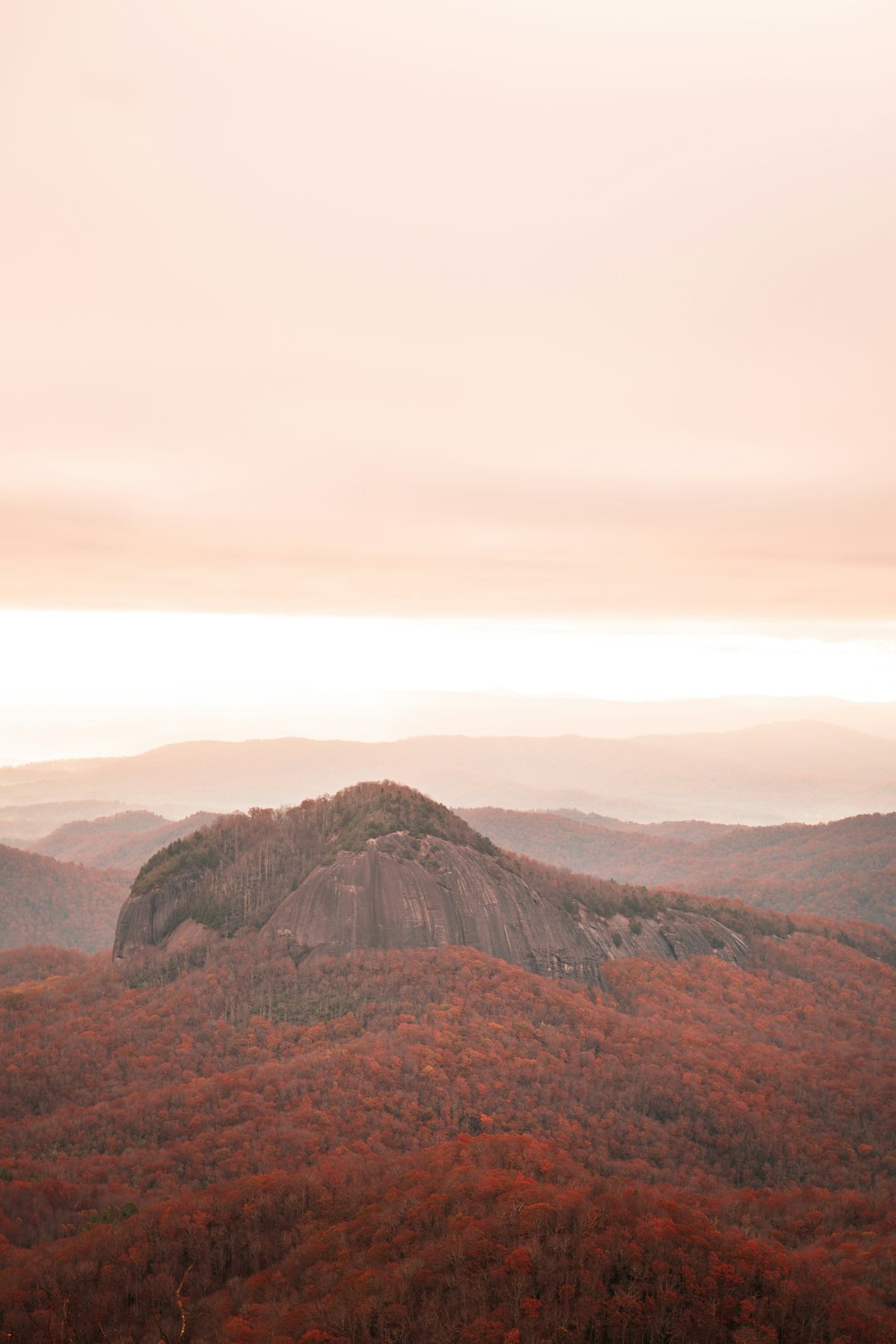 brown and green mountains under white sky during daytime