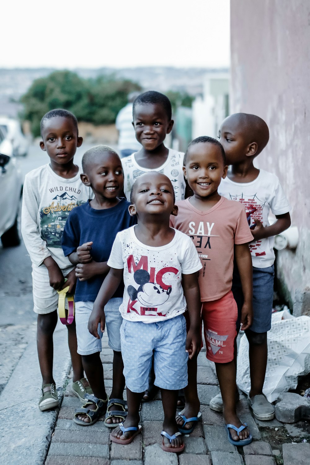 3 boys and 2 girls standing on gray concrete floor during daytime