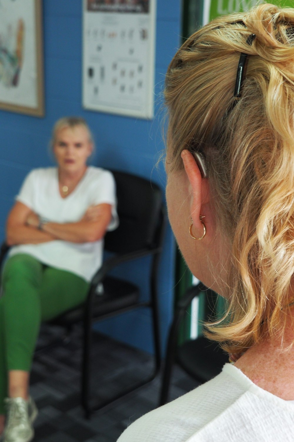 woman in green long sleeve shirt sitting on chair