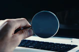 person holding round blue frame