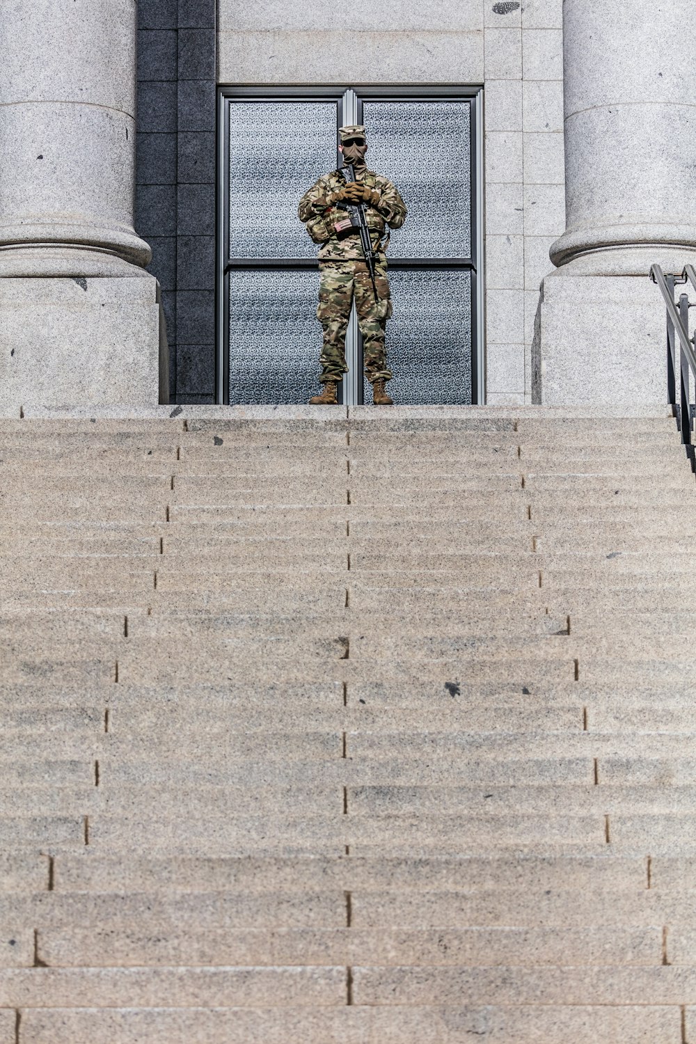 gold statue of man on gray concrete stairs