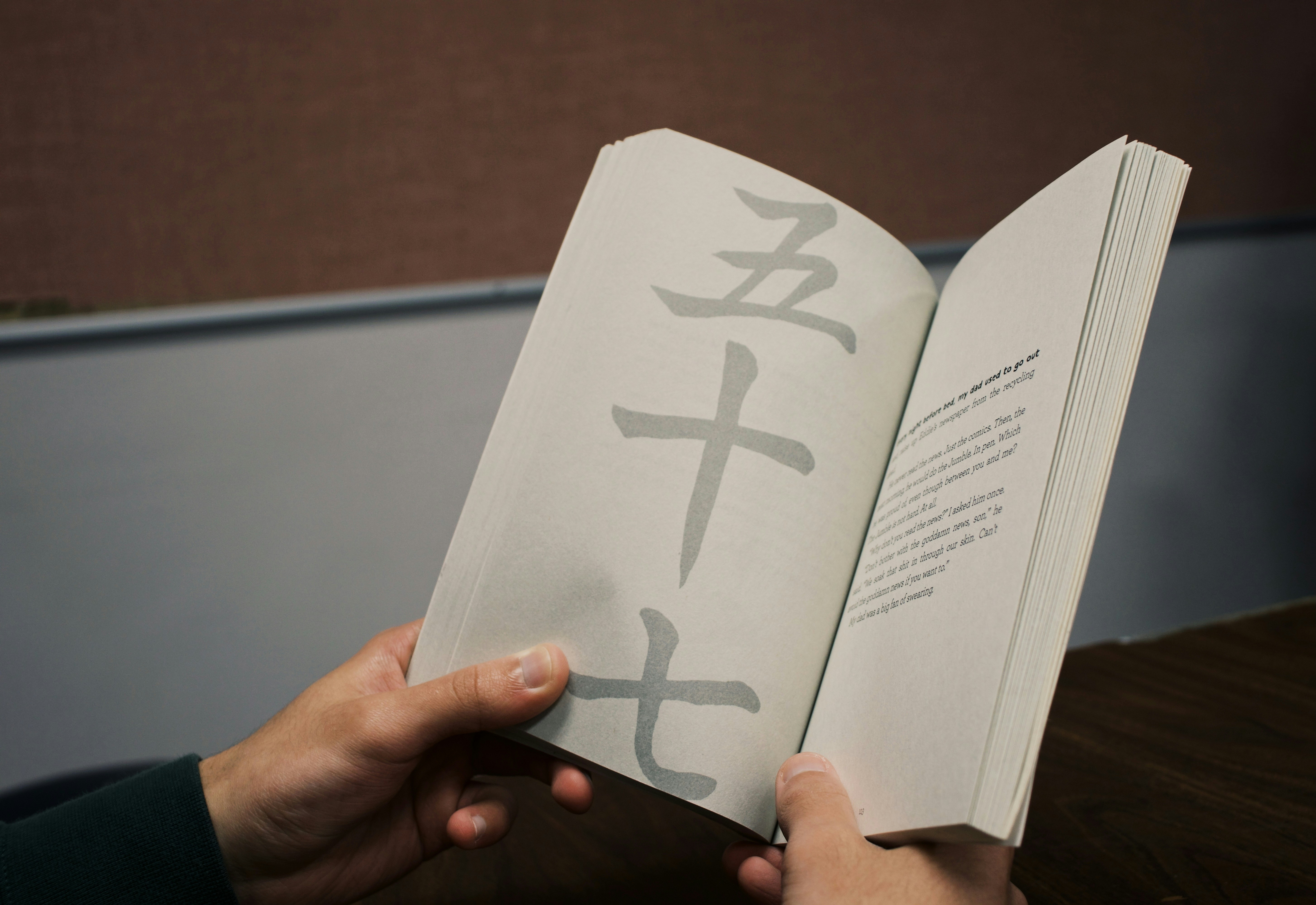 Person holding white printer paper