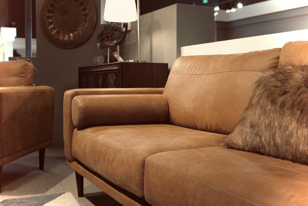 brown sofa near black round wall clock